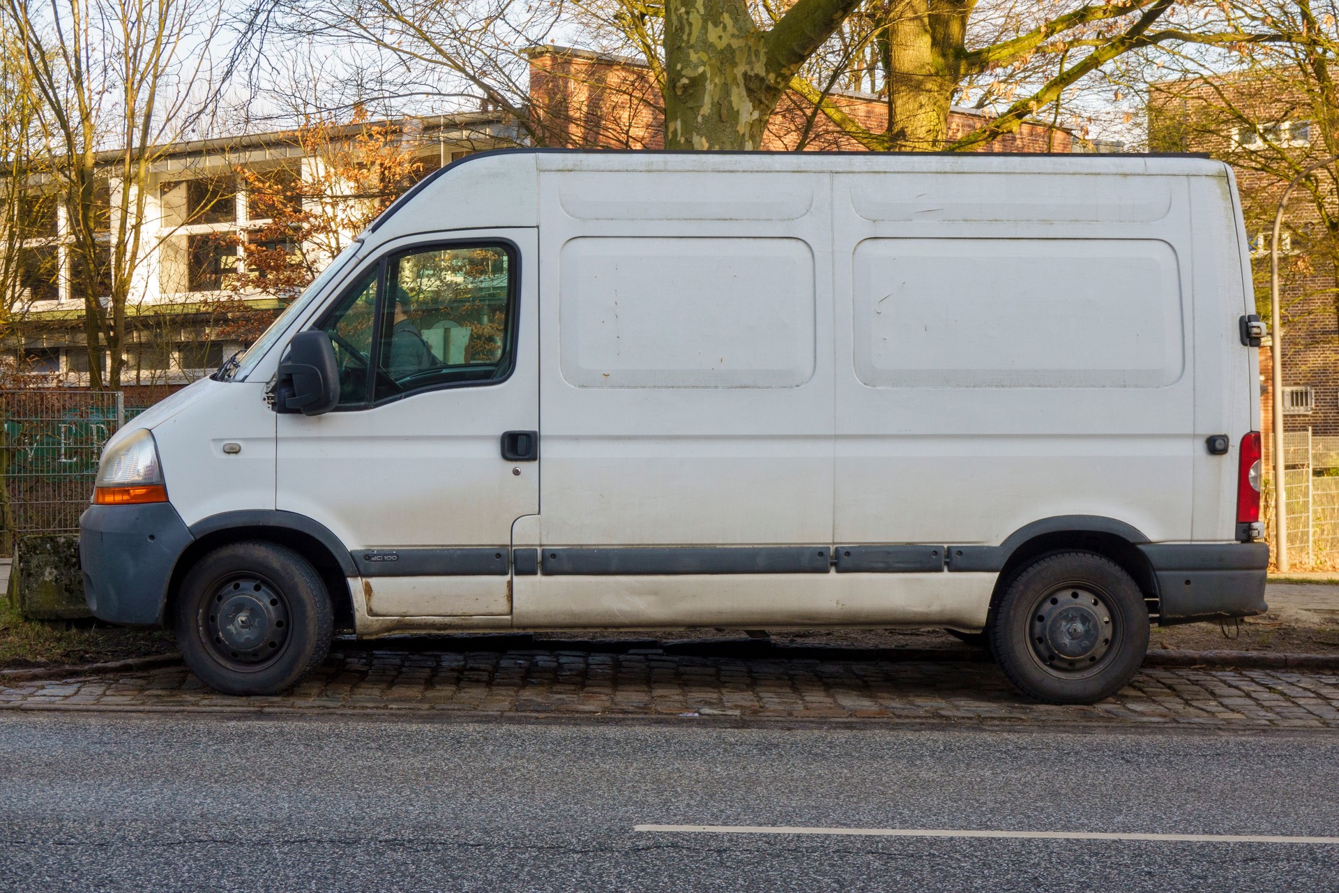 Old white van parked on the side of the road